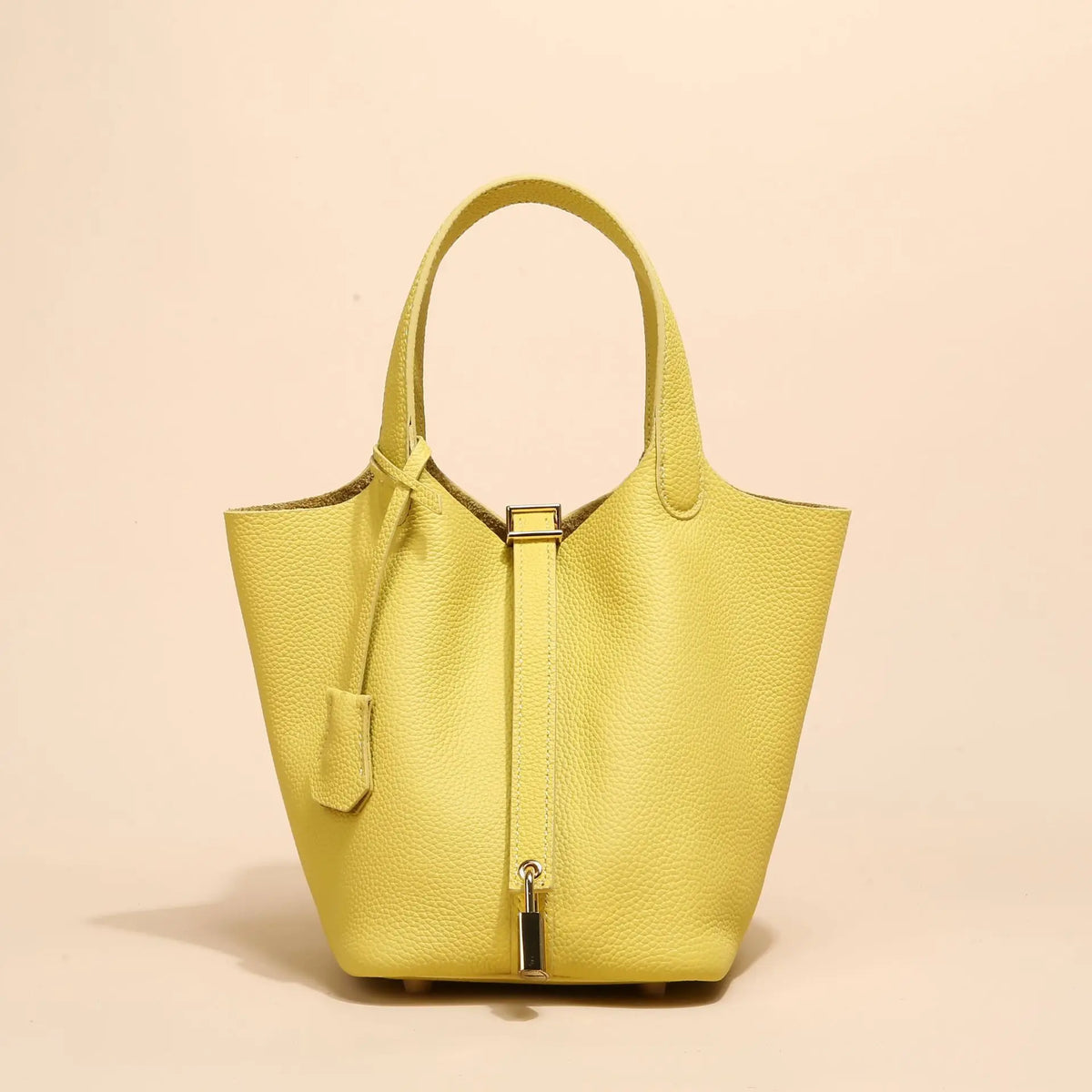 Helles gelbes Leder-Bucket-Bag mit goldfarbener Schnalle, von vorne.