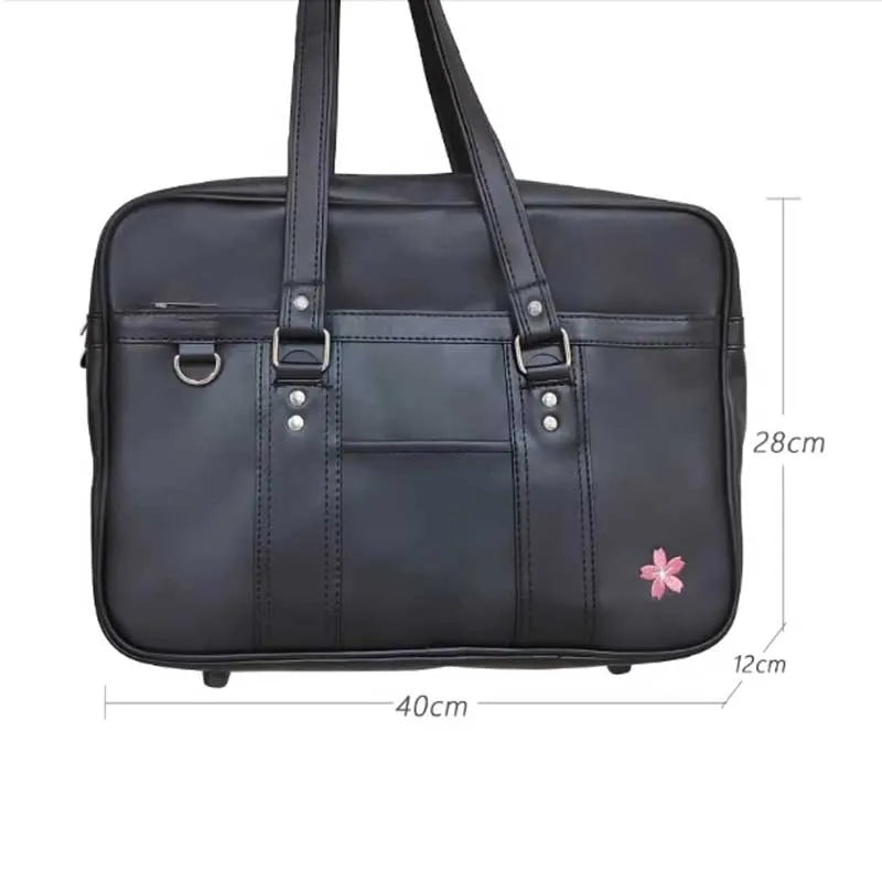 A black women's Japanese style PU shoulder bag with a flap and dual handles.
