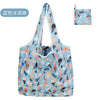 A light blue reusable eco tote shopping bag featuring a pattern of various fruits and leaves.