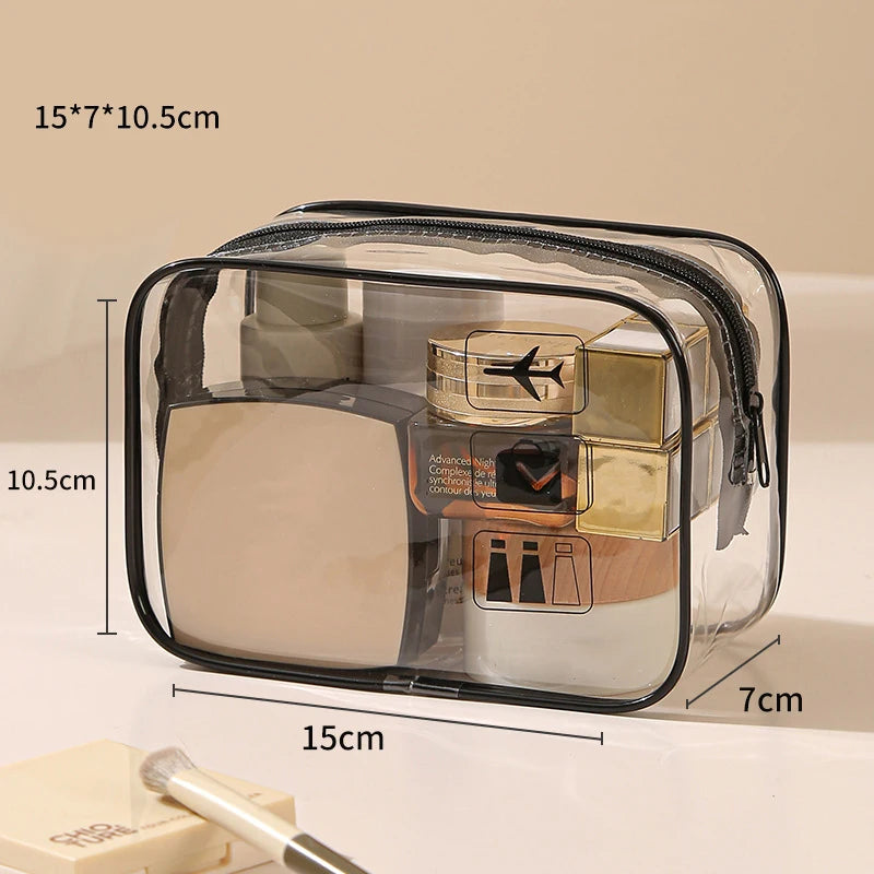 A clear plastic toiletry bag with a black zipper, showing various cosmetic items inside.