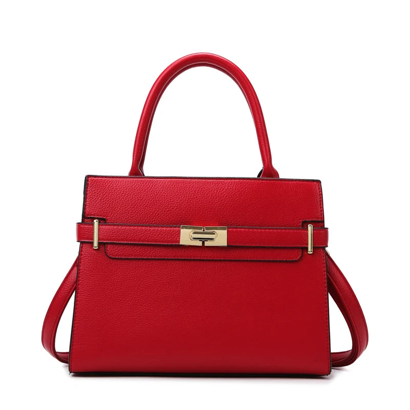 A red leather handbag with gold hardware shown from the front.