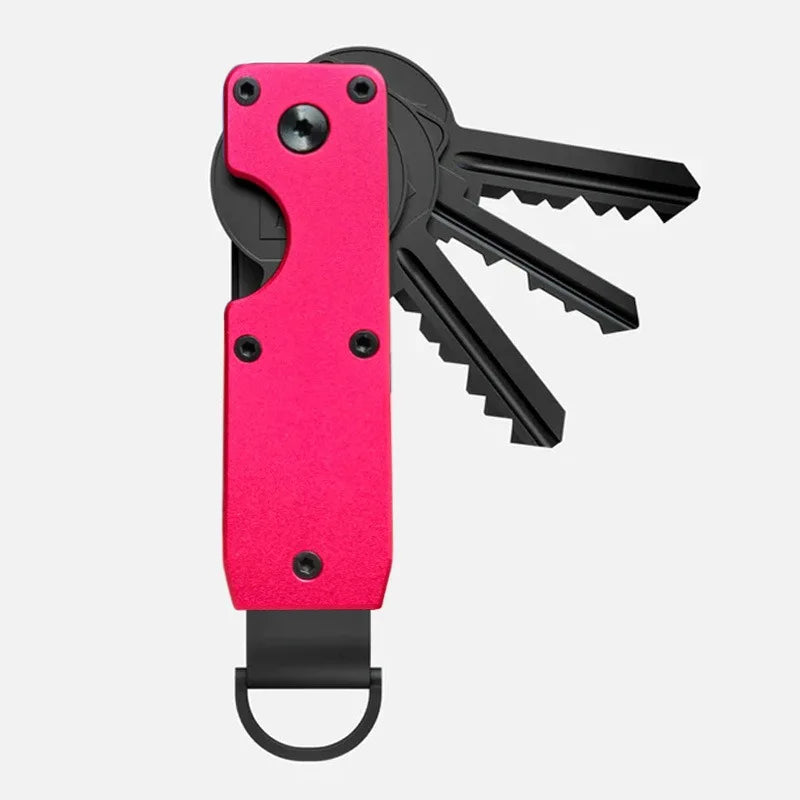 Porte-clés organisateur métallique minimaliste rose avec une clé noire attachée.