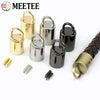 A collection of metal cord lock buckles in gold and black finishes, including various sizes and styles.
