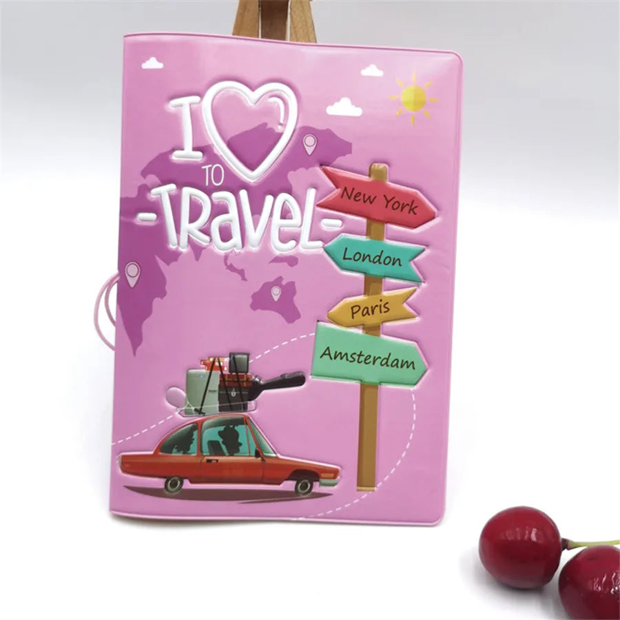 A pink passport cover featuring a 'I love to travel' design with silhouettes of major cities like New York, London, and Paris