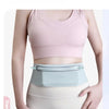 A woman wearing a light pink sports bra and a light blue waist pack for running.