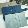 A stack of elegant blue and teal RFID blocking passport holders displayed on a white surface.