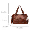 A brown leather tote bag featuring decorative rivets and handles, shown with dimension lines.