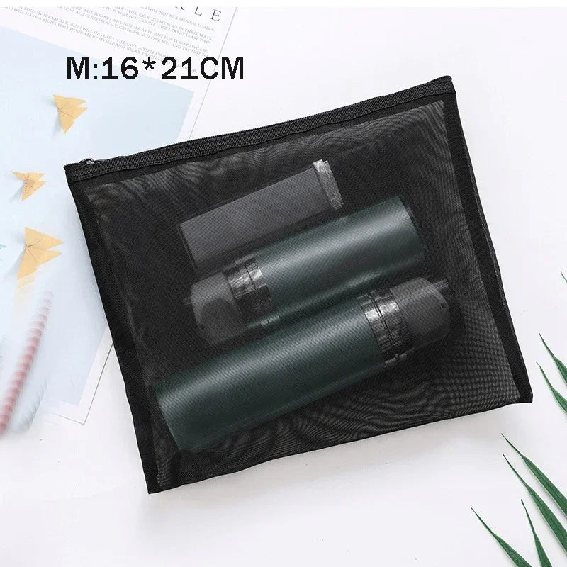 Black mesh storage pouch holding two dark cosmetic tubes, measuring 16x21cm.