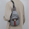 A man wears a beige shirt and a dark brown leather crossbody sling bag with a gray patterned fabric and green, red, and black