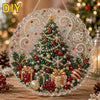 A clear resin Christmas tree ornament with a lace edge decorated with glitter, red berries, and gold accents.