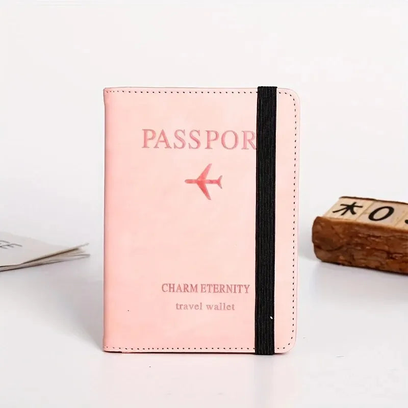 A pink passport wallet with black trim featuring a red airplane logo and the text Charm Eternity travel wallet.