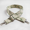A beige and green jacquard patterned strap for an adjustable wide crossbody bag.