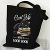 Black canvas tote bag featuring a black cat sitting on a stack of books with an orange butterfly print.