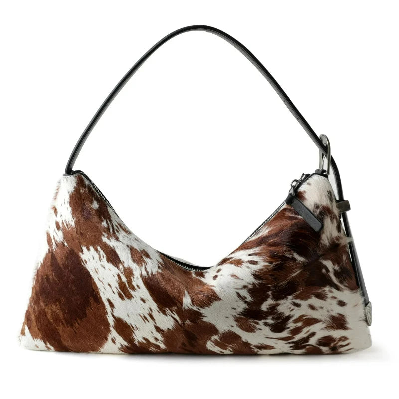 A brown and white spotted vintage horsehair and cowhide crossbody bag.