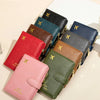 A stack of multi-functional PU leather passport wallets in various shades of green, brown, and blue.