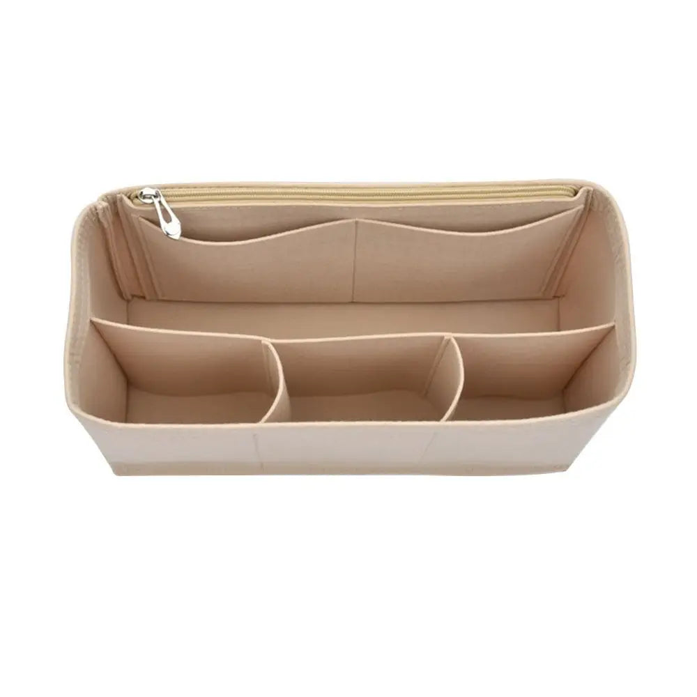 A light beige felt insert liner for a handbag, showing multiple divided compartments.