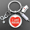 Silver nurse keychain featuring a heart design and a medical syringe charm