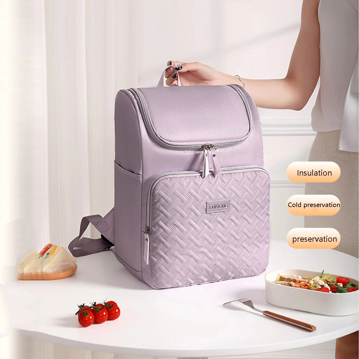 A purple insulated travel backpack is shown on a table next to food items, highlighting its insulation and preservation featu