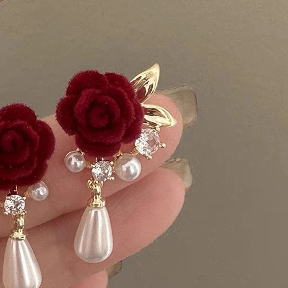 Gold-toned velvet rose earrings with clear and pearl accents