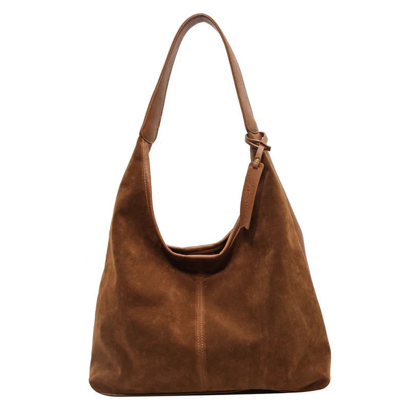 A brown suede slouchy shoulder bag with a long strap.