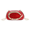 A red leather evening clutch bag with gold-tone hardware and a curved design.