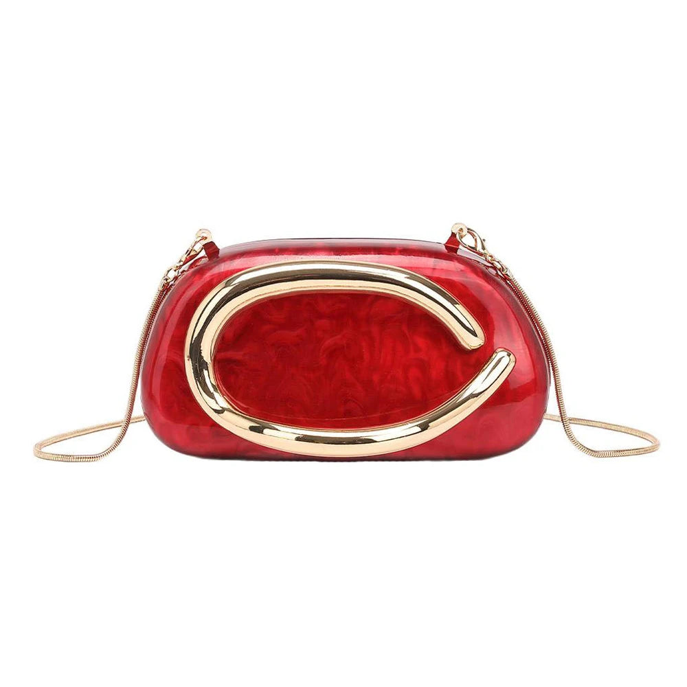 A red leather evening clutch bag with gold-tone hardware and a curved design.