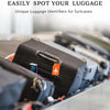 Close-up of black silicone luggage tags attached to suitcases on a conveyor belt.