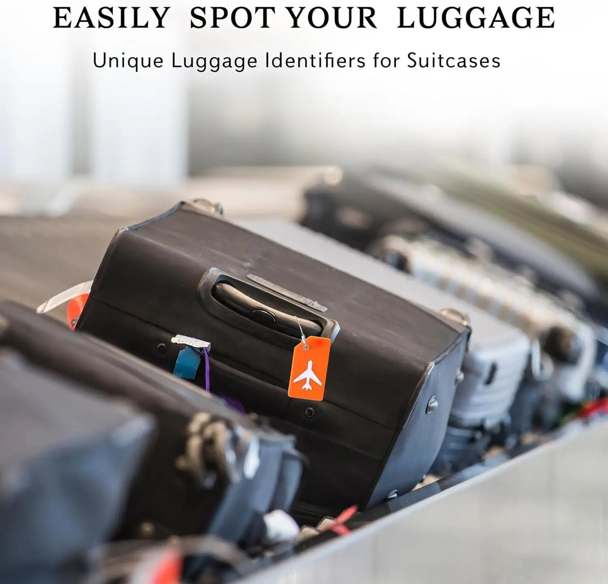 Close-up of black silicone luggage tags attached to suitcases on a conveyor belt.