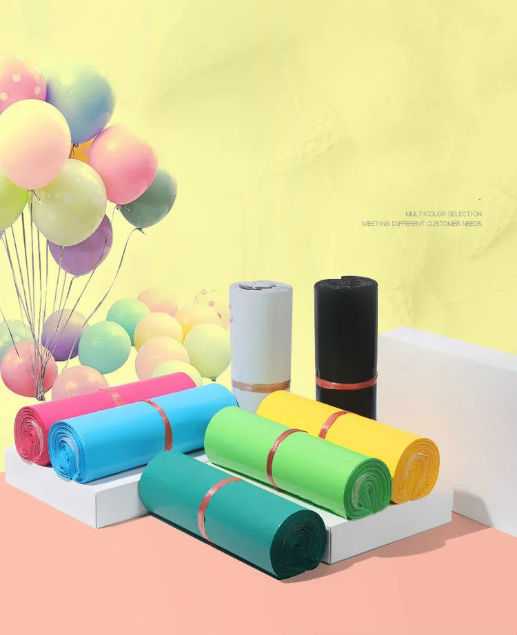 Varias bolsas de almacenamiento autoadhesivas de color rosa para envío y embalaje, exhibidas sobre una superficie blanca.