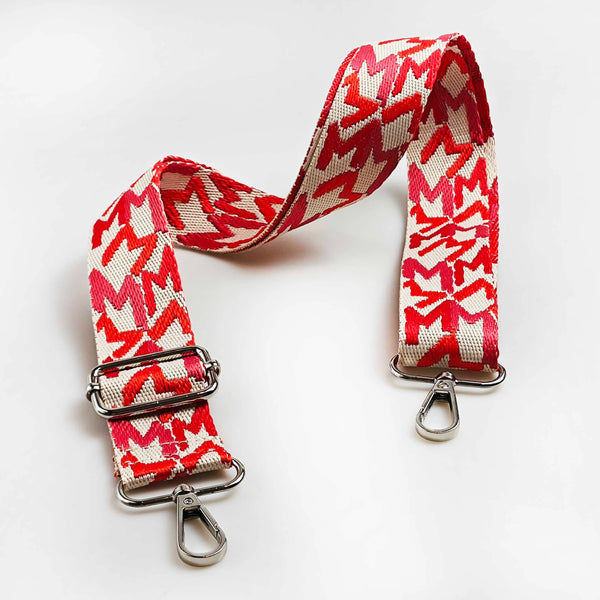 Red and white jacquard patterned strap for an adjustable wide crossbody bag.