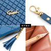 A blue quilted clutch wallet with a gold clasp and tassel detail shown in various angles.