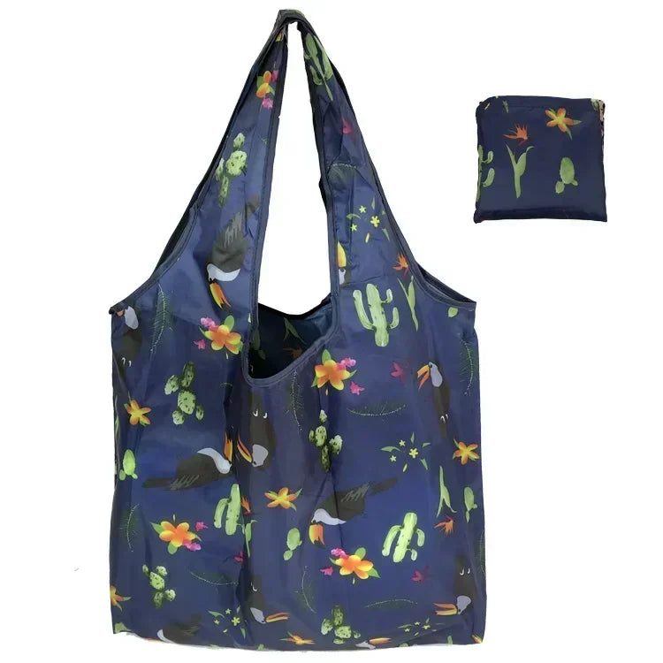 A dark blue fabric tote bag with a floral print featuring green and yellow elements.