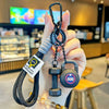 A hand holds a black D-shape nylon fitness keychain with a 500 lb weight and a star design.
