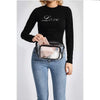 A woman wearing a black long-sleeve shirt and jeans holds a clear waterproof transparent fanny pack.