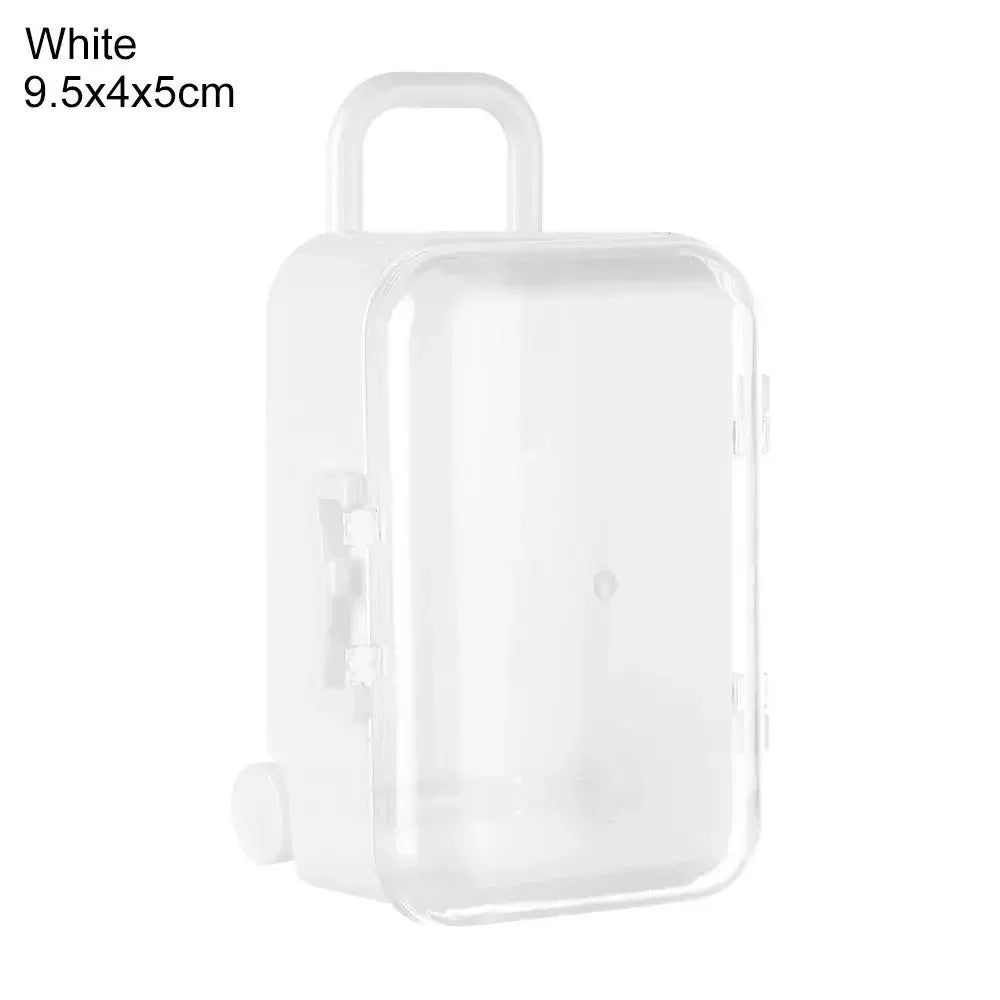 A white miniature doll suitcase with a handle, clear plastic body, shown from the front.