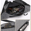 A gray canvas waist fanny bag is shown open, displaying various accessories inside.