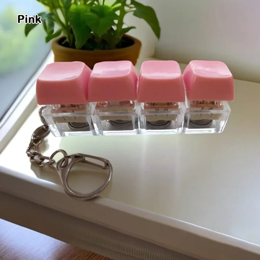 Pink tactile stress relief keyboard fidget toy with square pink buttons and a silver chain