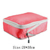 A pink reusable compression packing cube with a silver zipper and a black pull tab.