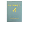 A light blue passport holder made of PU leather with gold lettering and an embroidered airplane symbol.