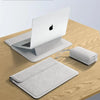 A white premium PU laptop sleeve is shown next to an Apple laptop and a matching sleeve on a wooden surface.