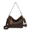 Brown leather crossbody tote bag with gold hardware and a repeating monogram pattern