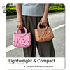 A person holds a pink PVC handbag with a butterfly hole design against a blurred outdoor background.
