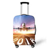 A silver rolling suitcase with a vibrant sunset landscape on the cover.