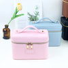 A pink customizable PU leather makeup bag with a zipper and handle is displayed next to a light blue version.