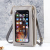 A light beige women's multi-color crossbody cell phone bag with a clear window displaying a smartphone.