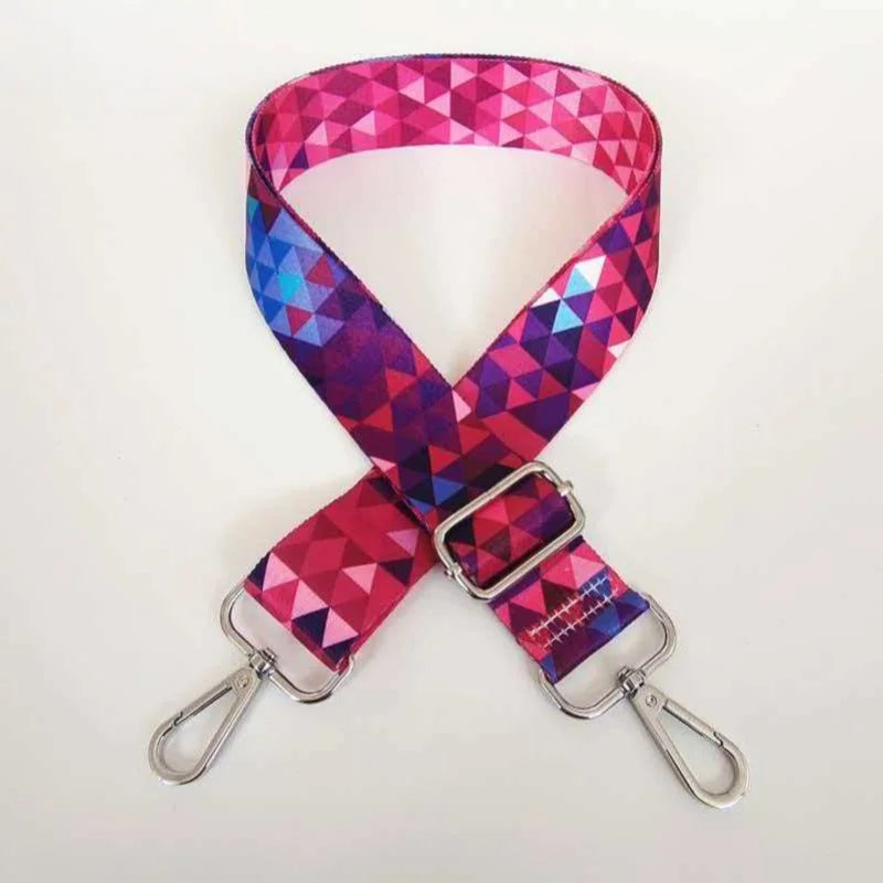 A vibrant pink and purple geometric patterned adjustable crossbody strap for a handbag.
