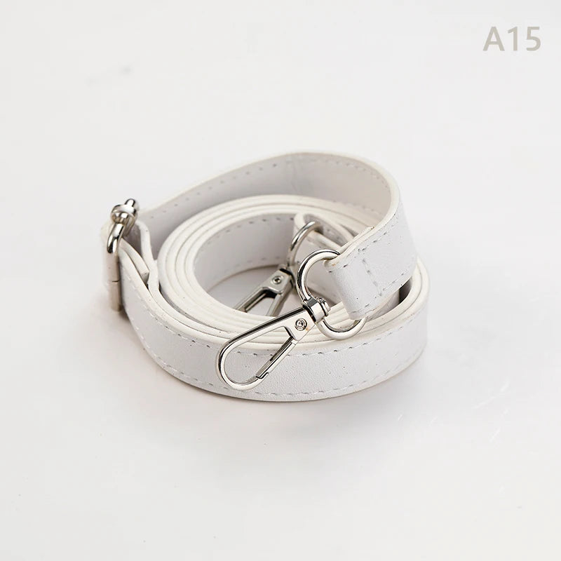 A white PU leather strap for a crossbody bag, coiled and showing the metal hardware.