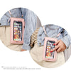 A pink multi-color crossbody cell phone bag is shown being worn on a denim jacket and light colored shirt.
