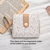 A light pink coin purse and card holder wallet featuring a pattern of cute cartoon cats on white fabric.