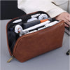 A brown leather multi-layer cable organizer pouch is shown open, displaying various white and black electronic cables and acc